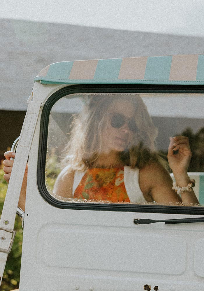 Model behind the vintage car's windshield