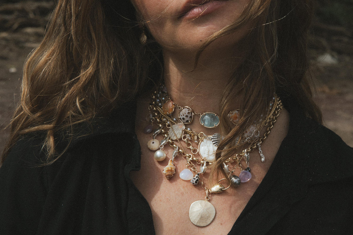 Layered shell necklaces on a black top