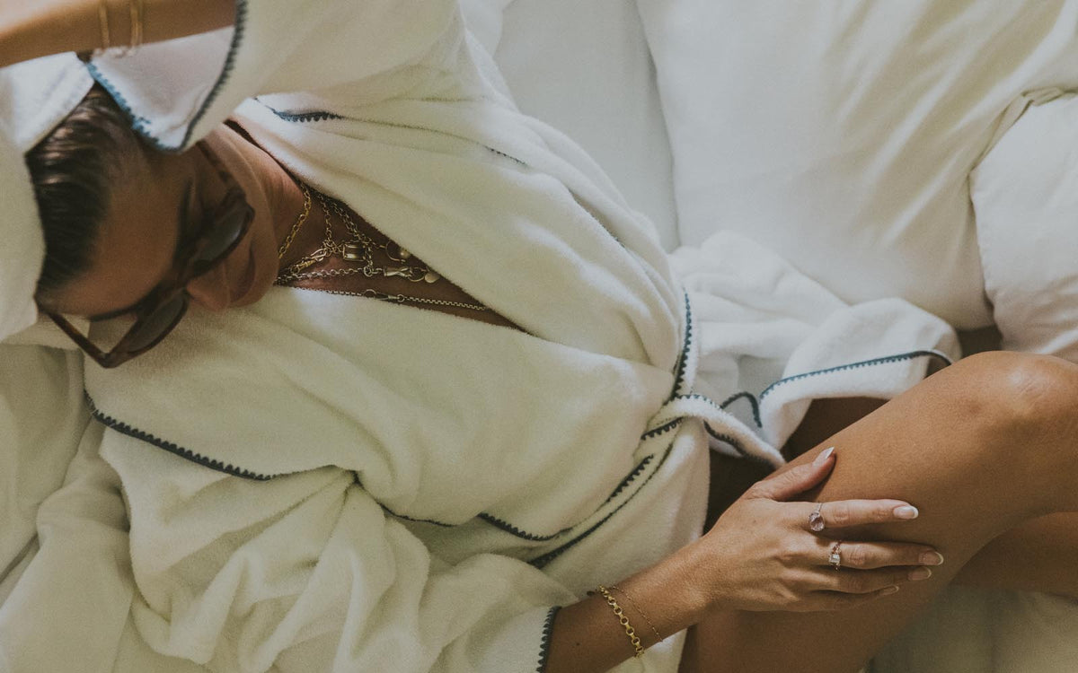 Model in a white robe lying down