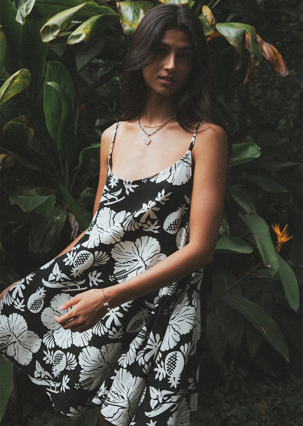 Model in a tropical print dress in the garden