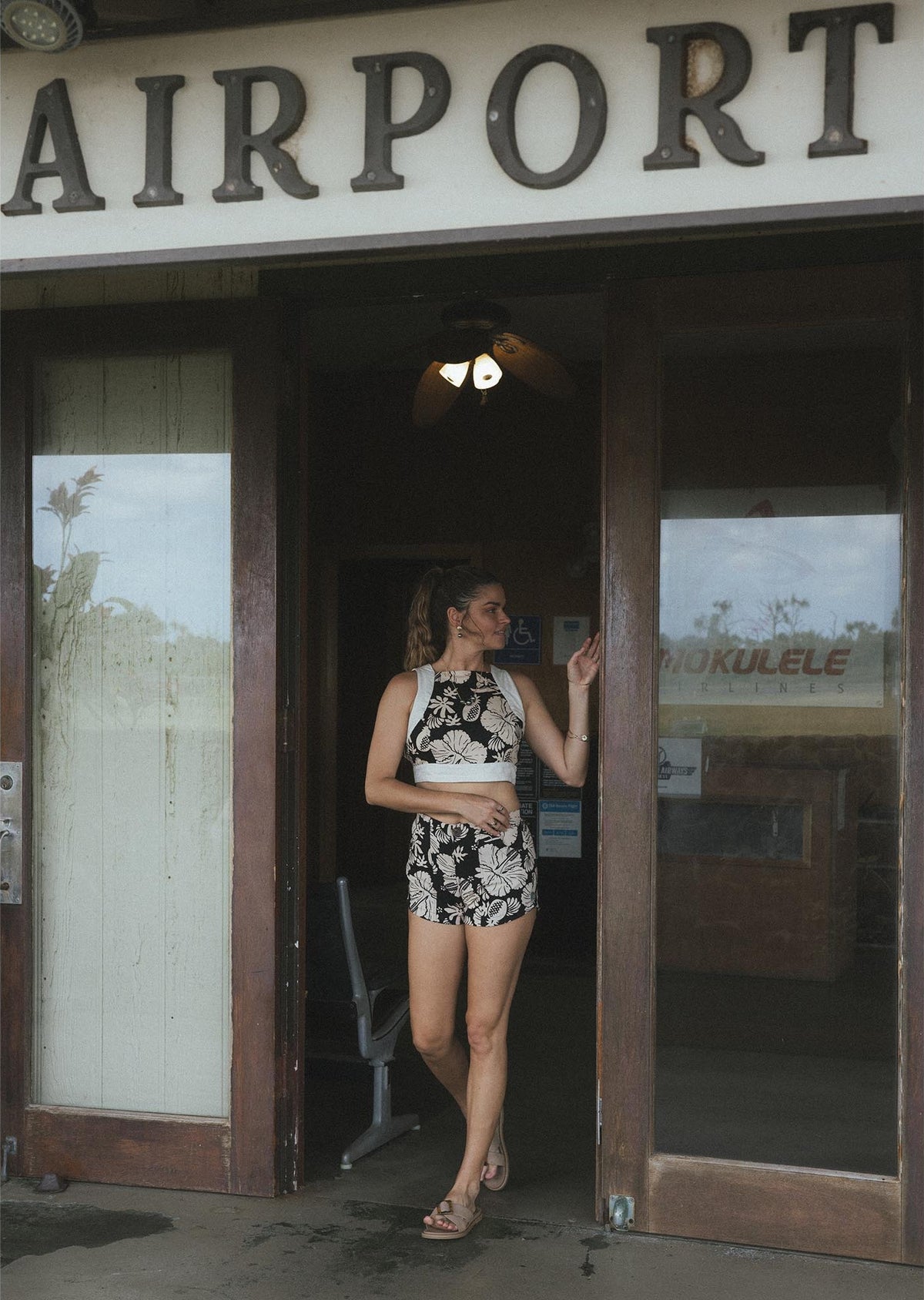 Model walking out of an airport door