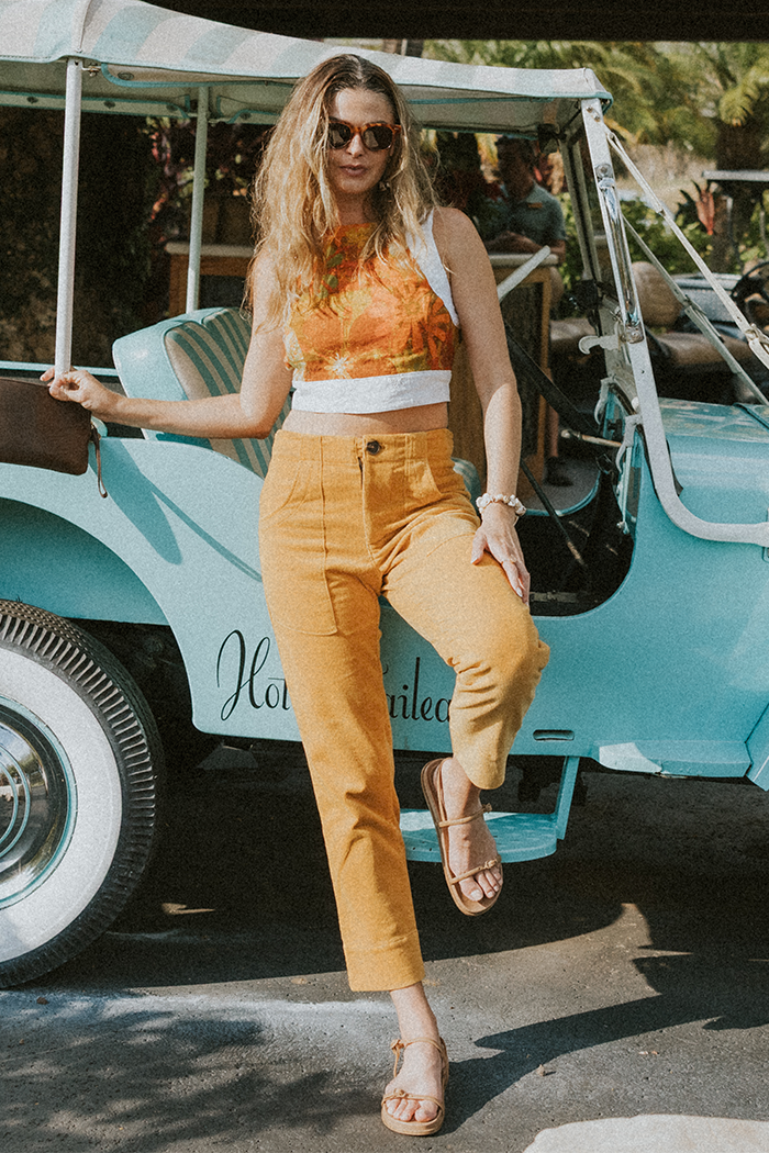 Model wearing Wings Hawaii retro pocket pants in marigold corduroy