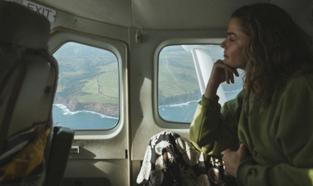 Model looking out of a plane window