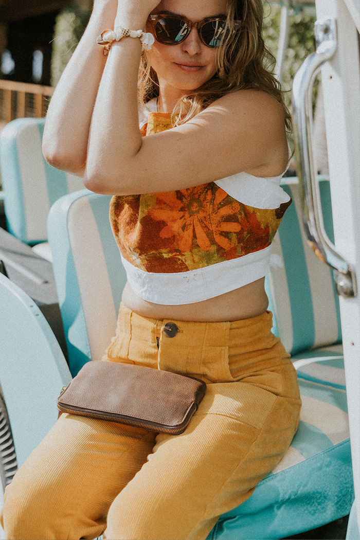 Model wearing Wings Hawaii retro pocket pants in marigold corduroy