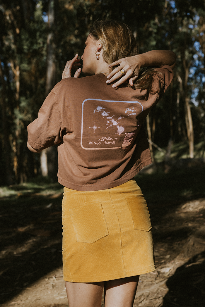 Wings Hawaii model wearing Oversized Cropped Tee - Hawaii Map in brown - back 