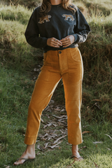 Model wearing Wings Hawaii retro pocket pants in marigold corduroy thumbnail