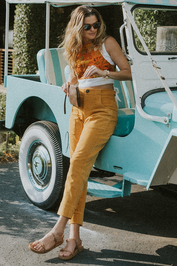 Model wearing Wings Hawaii retro pocket pants in marigold corduroy