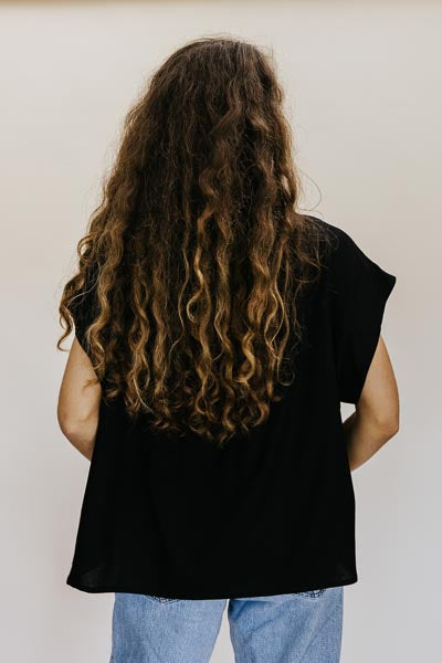 Wings Hawaii model wearing Classic Black Boxy Button-up - back 