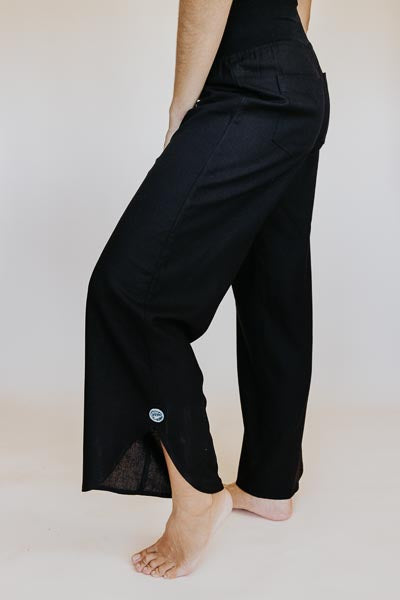 Wings Hawaii best-selling women's Pau Hana pants in classic black. Soft, stretchy waistband and scalloped hem. Small batch, sustainable clothing designed in Maui, sewn in Bali. 