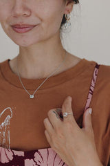 model wearing wings hawaii prong set sunstone necklace in 14k white gold  thumbnail