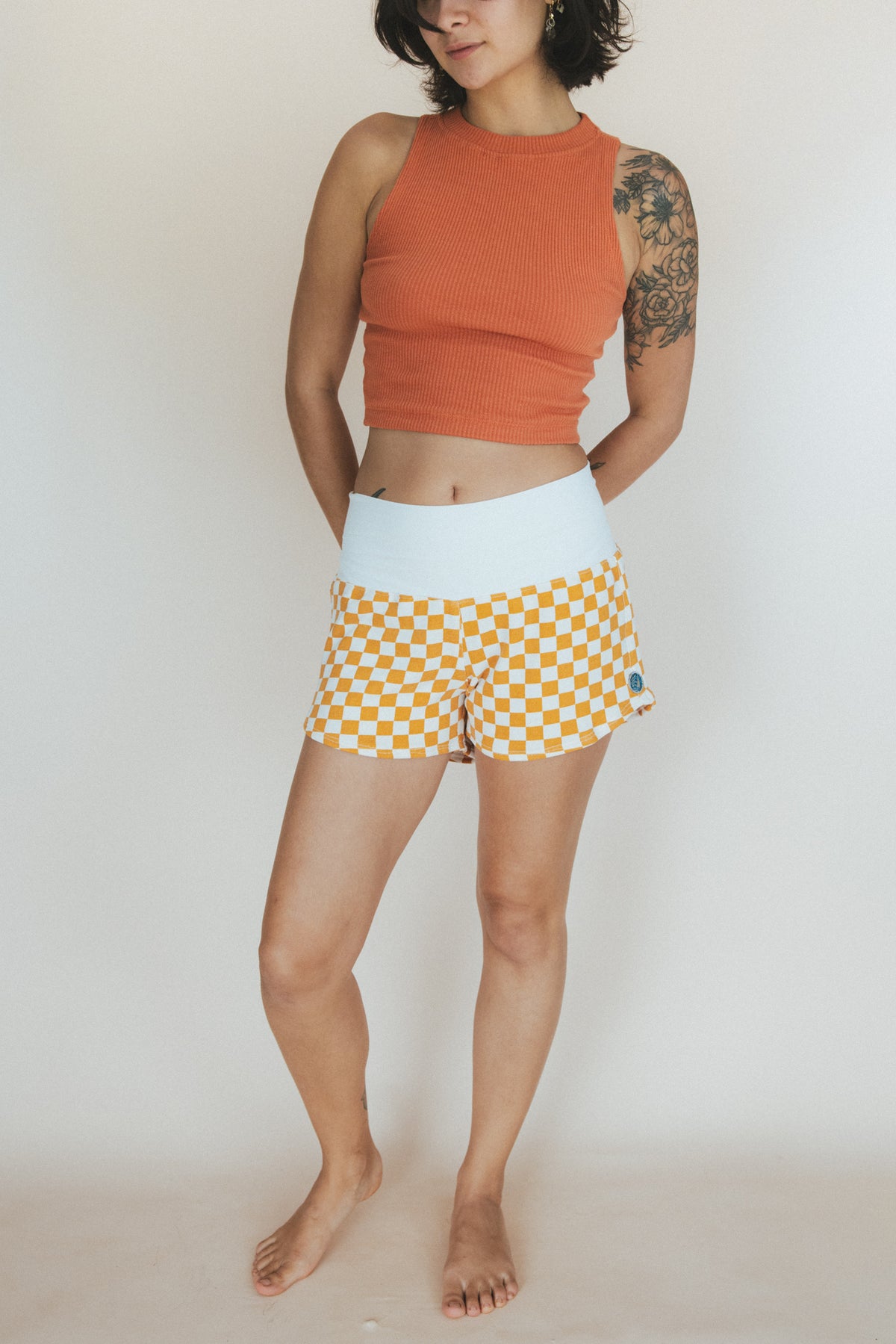 Wings Hawaii original pau hana shorts in french cotton terry. Orange and white checkerboard print with thick, stretchy, comfortable waistband. Designed in Maui for the boho, beachy chic lifestyle. 