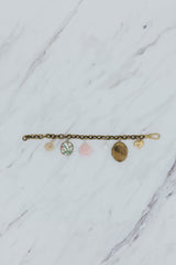 Wings Hawaii Vintage Charm Bracelet. Brass chain with mix of vintage charms, pink opal, pearls, and a locket. Fine jewelry handcrafted in Maui.  thumbnail
