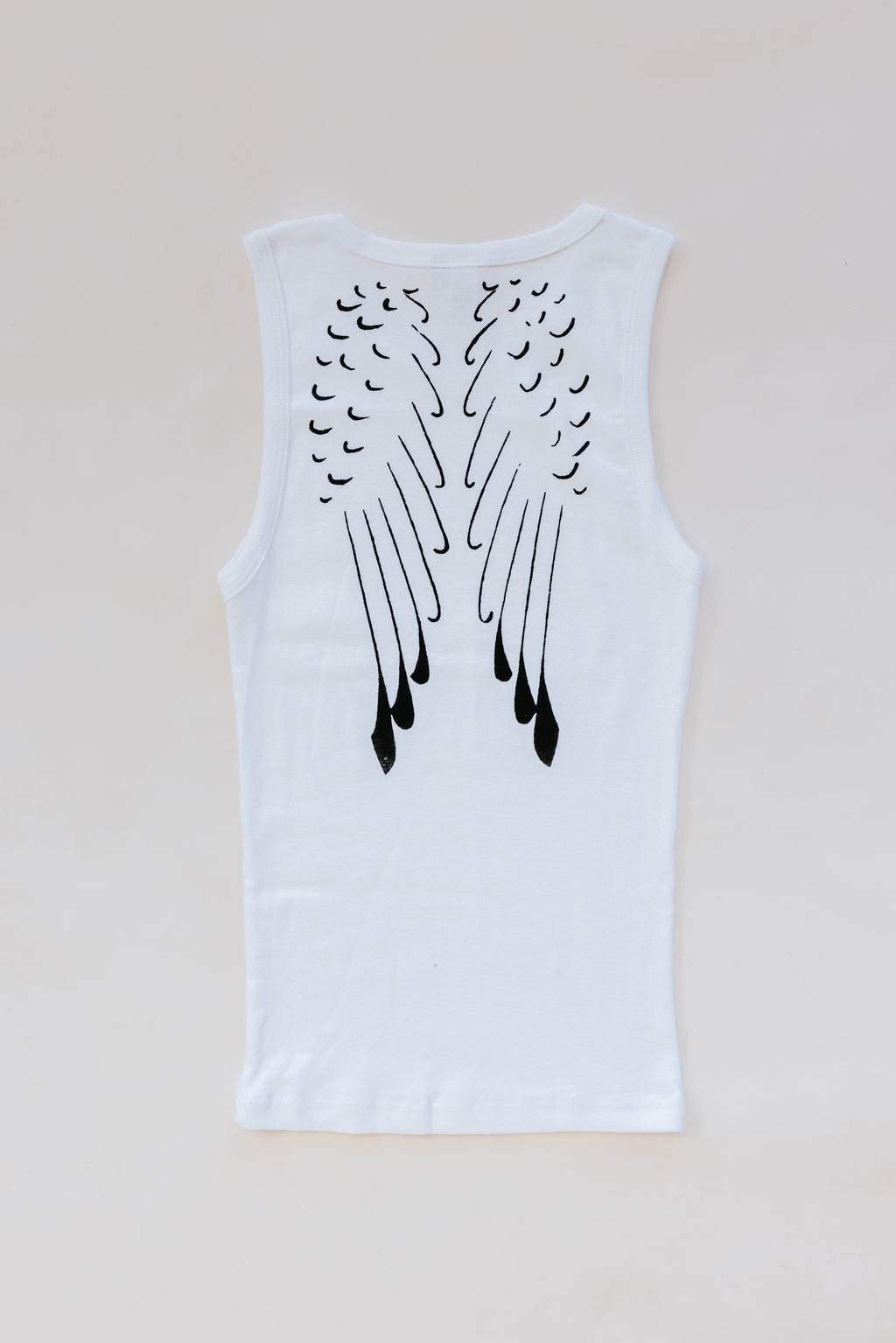 Wings Hawaii White Wing Tank. Angel wings in black print on white cotton tank top. Screenprinted by hand in Haiku, Maui. Original, sustainable, slow fashion made in Hawaii. 