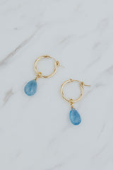 Wings Hawaii faceted aquamarine charms in 14k gold filled shown on hoop earrings. Fine jewelry handmade in Maui. Modern, elevated charm earrings to mix, match, customize.