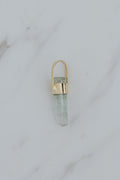Wings Hawaii raw tourmaline necklace charm in solid 14k yellow gold. Aqua blue-green gemstone with raw cut. Earthy, boho fine jewelry handcrafted in Maui. 