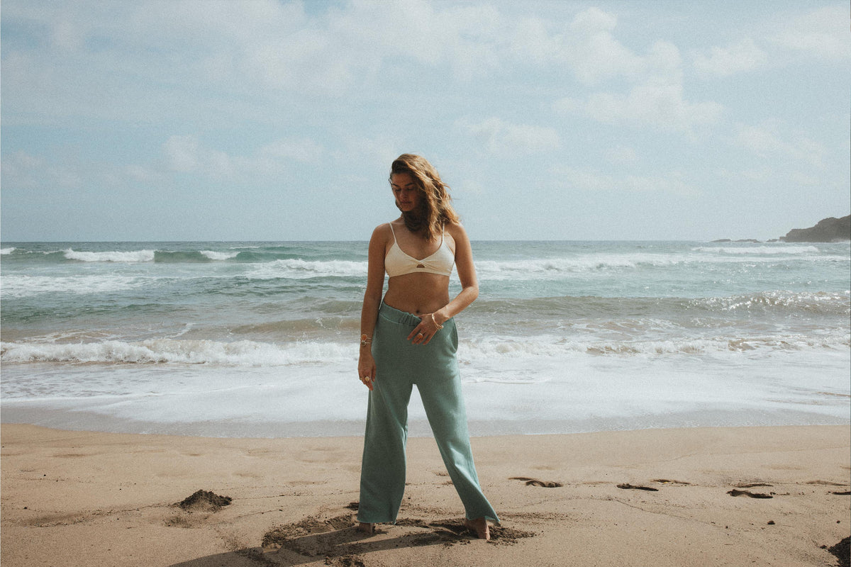 Model in sage beach pants on the beach