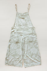 Wings Hawaii women's aloha print overalls in Hana Pearl. Designed in Maui, made in Bali. Cream white neutral tropical pattern with hibiscus florals, pineapples, and Hawaiian outrigger canoes. Adjustable straps, wide leg, relaxed fit, front and side pockets. Small batch, sustainable clothing for beachy, boho style.  thumbnail