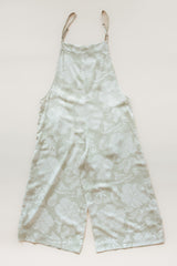 Wings Hawaii women's aloha print overalls in Hana Pearl. Designed in Maui, made in Bali. Cream white neutral tropical pattern with hibiscus florals, pineapples, and Hawaiian outrigger canoes. Adjustable straps, wide leg, relaxed fit, front and side pockets. Small batch, sustainable clothing for beachy, boho style.  thumbnail
