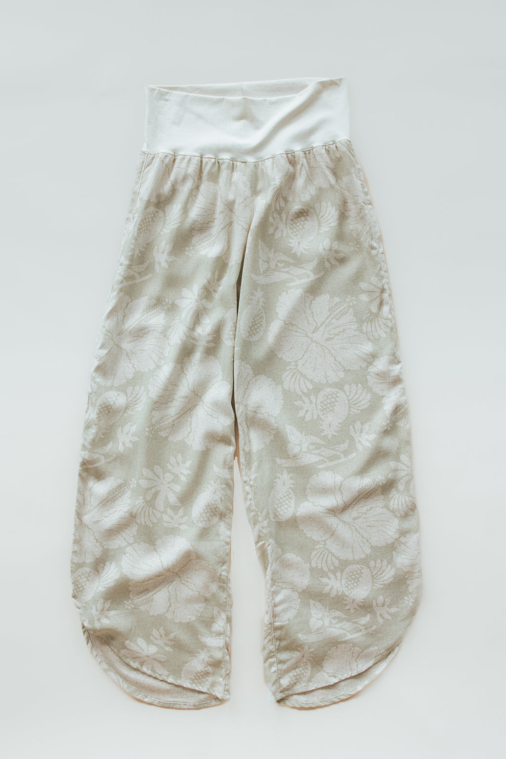 Wings Hawaii pau hana pants in Hana Pearl. Cream white tropical aloha print. Designed in Maui, sewn in Bali. Small batch, sustainable apparel. Beachy, boho, coastal, surfer girl, ocean-inspired style. 