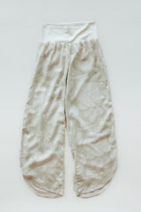 Wings Hawaii pau hana pants in Hana Pearl. Cream white tropical aloha print. Designed in Maui, sewn in Bali. Small batch, sustainable apparel. Beachy, boho, coastal, surfer girl, ocean-inspired style.  thumbnail