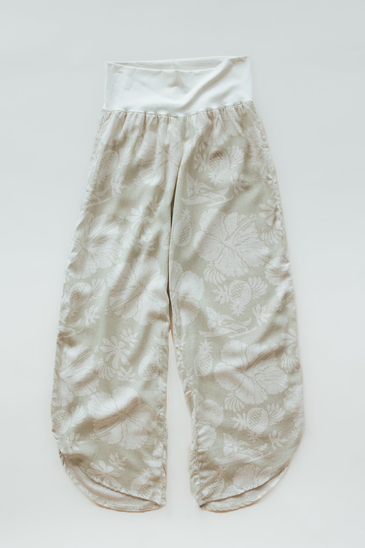Wings Hawaii pau hana pants in Hana Pearl. Cream white tropical aloha print. Designed in Maui, sewn in Bali. Small batch, sustainable apparel. Beachy, boho, coastal, surfer girl, ocean-inspired style. 