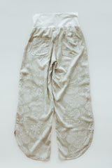 Wings Hawaii pau hana pants in Hana Pearl. Cream white tropical aloha print. Designed in Maui, sewn in Bali. Small batch, sustainable apparel. Beachy, boho, coastal, surfer girl, ocean-inspired style.  thumbnail