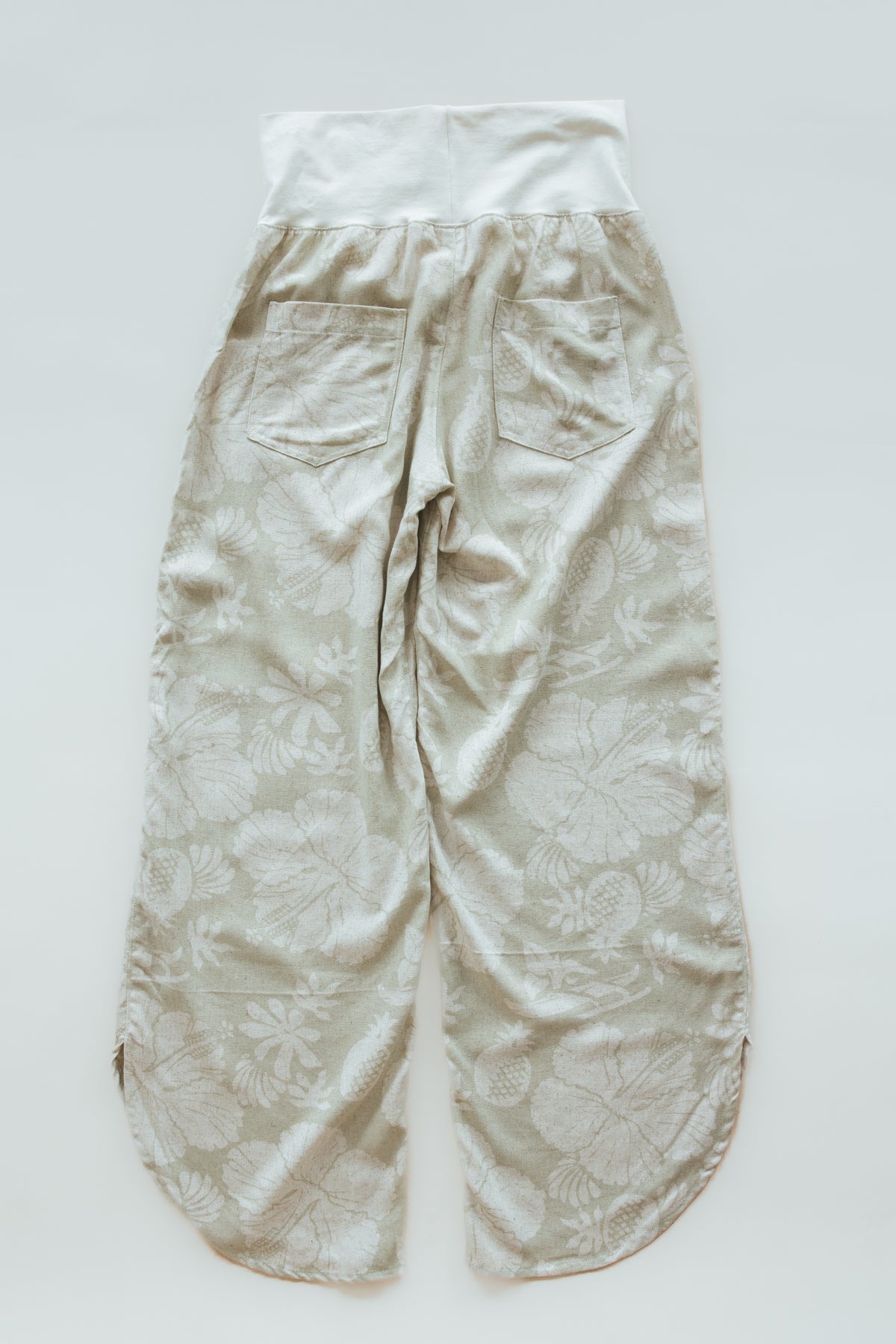 Wings Hawaii pau hana pants in Hana Pearl. Cream white tropical aloha print. Designed in Maui, sewn in Bali. Small batch, sustainable apparel. Beachy, boho, coastal, surfer girl, ocean-inspired style. 