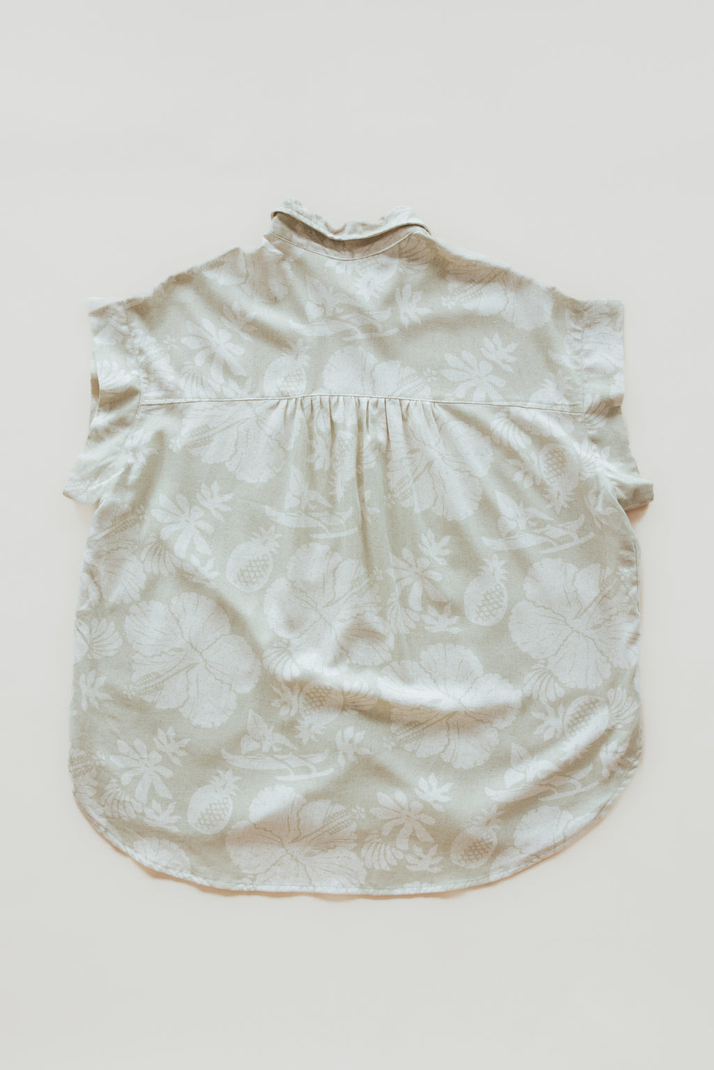 Wings Hawaii women's Short Sleeve Pocket Blouse in beige Hana Pearl muted aloha print. Designed in Maui, made in Bali. Elevated, chic aloha wear sustainably handcrafted in small batches. 