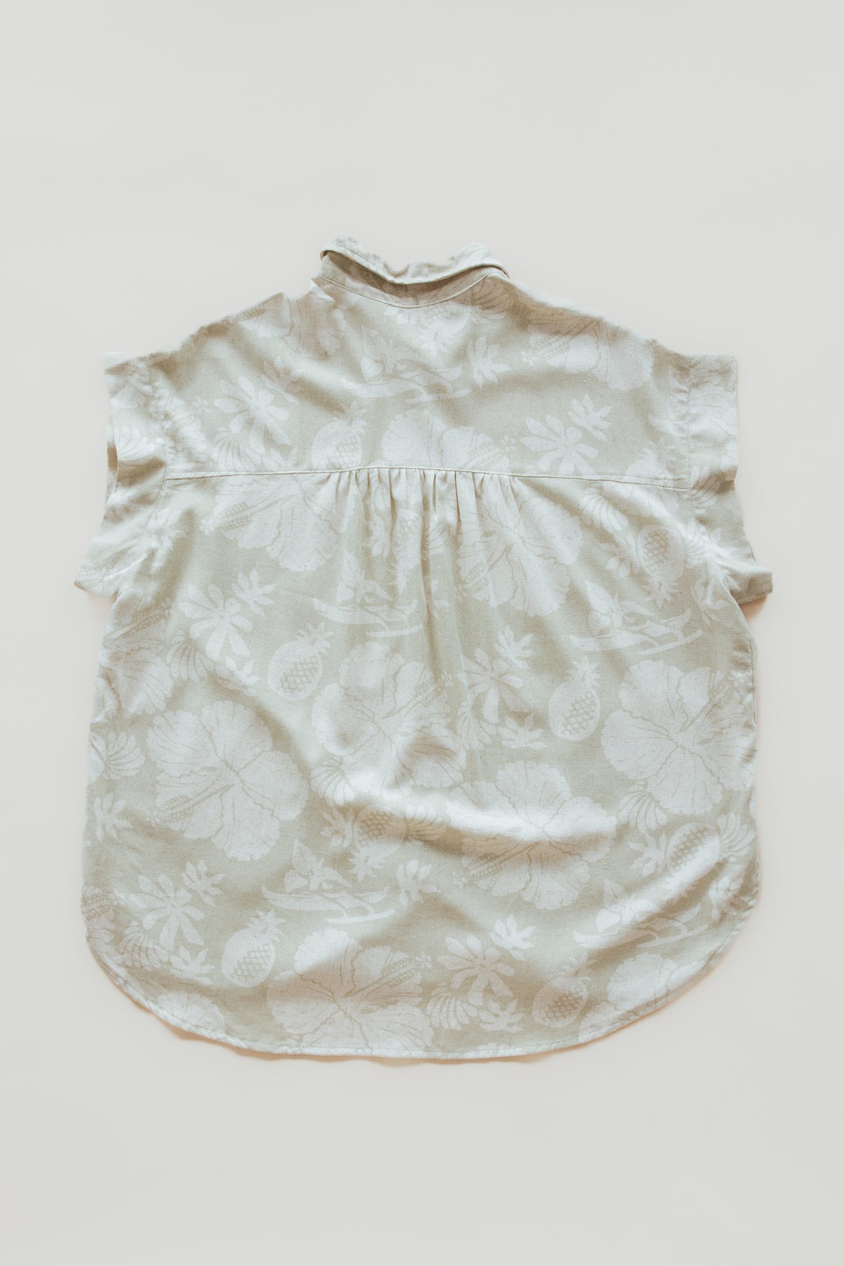 Wings Hawaii women's Short Sleeve Pocket Blouse in beige Hana Pearl muted aloha print. Designed in Maui, made in Bali. Elevated, chic aloha wear sustainably handcrafted in small batches. 