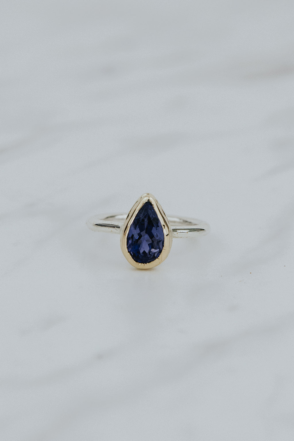 Wings Hawaii Teardrop Iolite gemstone ring. 3.24ct natural blue Iolite set in solid 14k yellow gold on a sterling silver  band. One of a kind. Fine jewelry expertly handcrafted in Maui. 