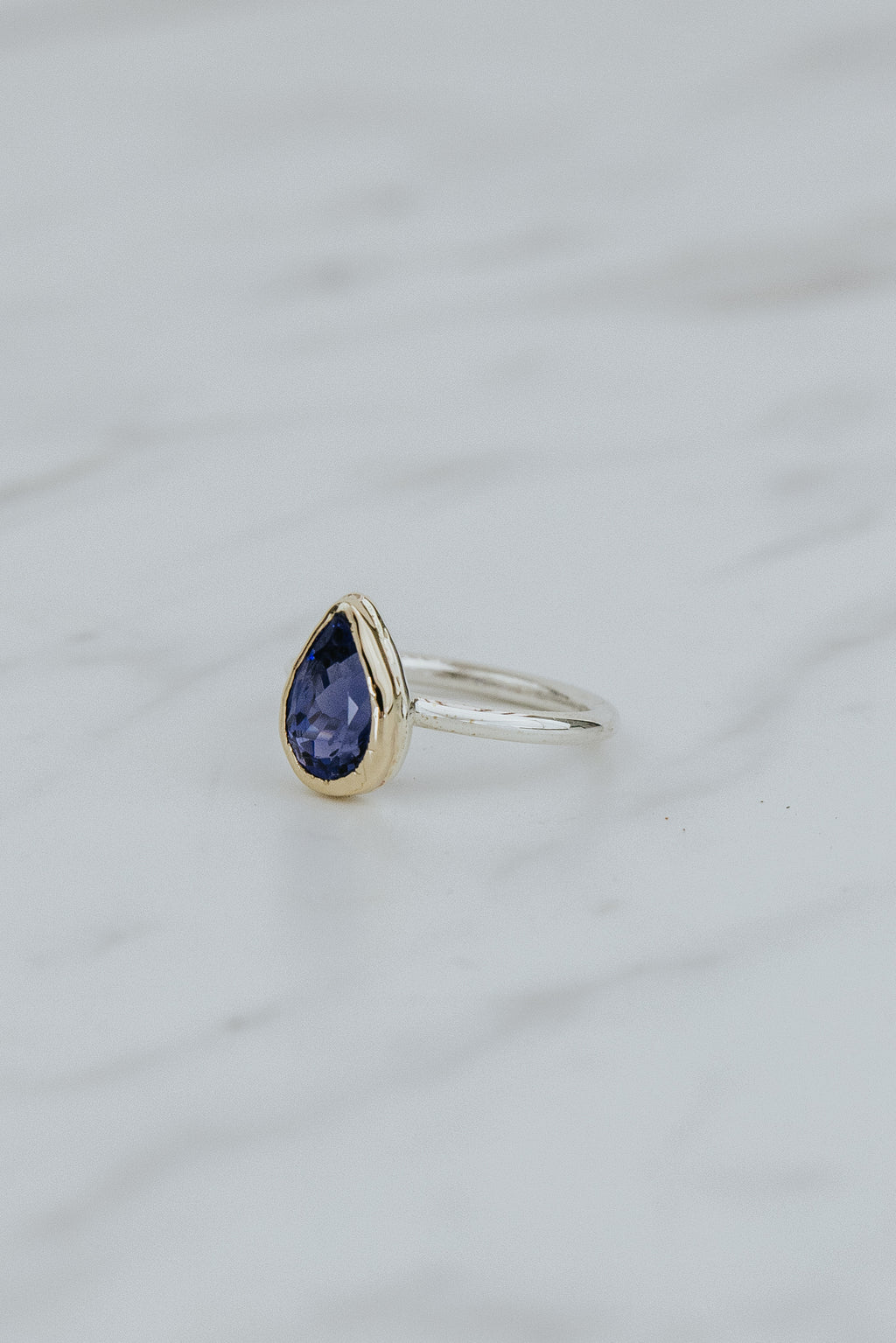 Wings Hawaii Teardrop Iolite gemstone ring. 3.24ct natural blue Iolite set in solid 14k yellow gold on a sterling silver  band. One of a kind. Fine jewelry expertly handcrafted in Maui. 