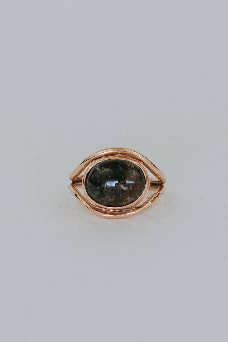 A Tourmaline set in 14K Yellow Gold int he shape of an evil eye