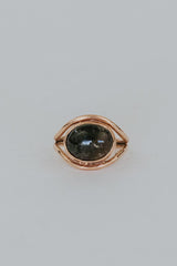 A Tourmaline set in 14K Yellow Gold int he shape of an evil eye