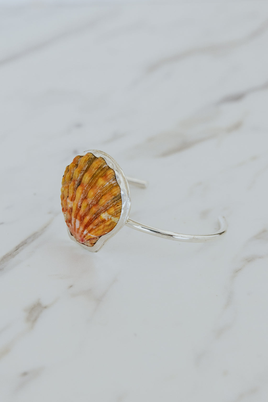 Wings Hawaii Sunrise Shell Cuff. Authentic Hawaiian beach shell on sterling silver bracelet. Fine jewelry handmade with aloha on Maui. One of a kind gifts made in Hawaii. 