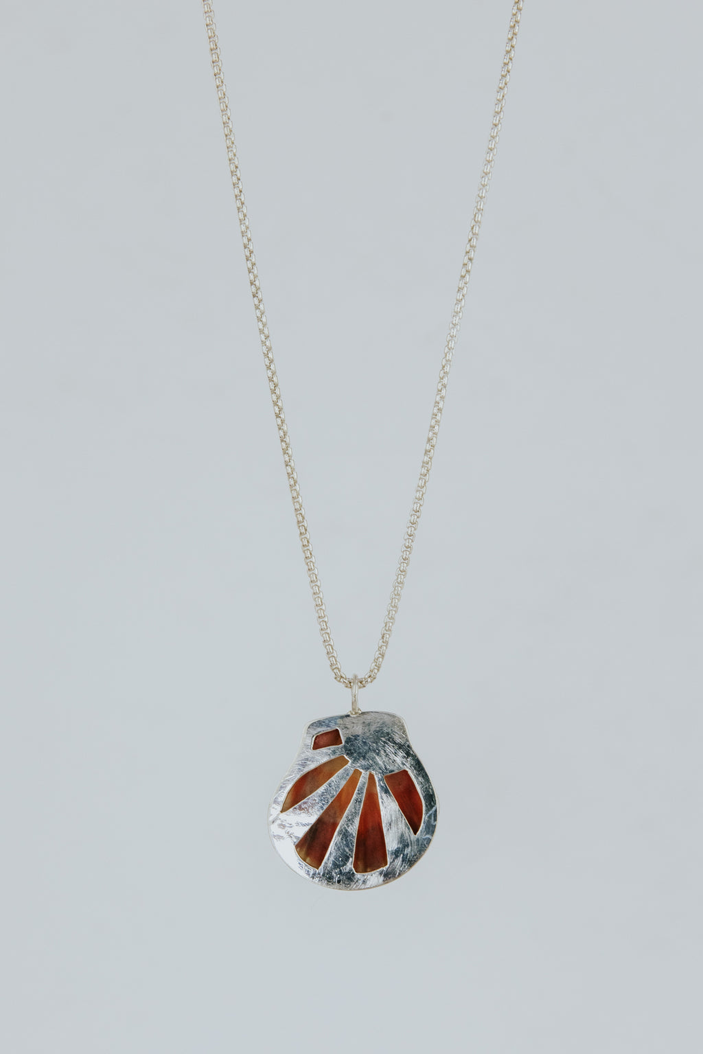 Wings Hawaii bezel-set Sunrise Shell necklace. Authentic, rare Hawaiian beach shell on sterling silver chain necklace. Fine jewelry handmade with aloha on Maui. One of a kind gifts made in Hawaii.
