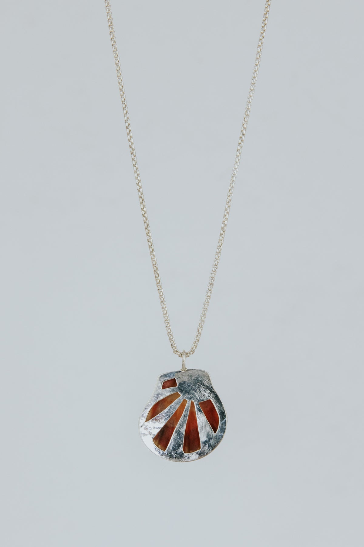 Wings Hawaii bezel-set Sunrise Shell necklace. Authentic, rare Hawaiian beach shell on sterling silver chain necklace. Fine jewelry handmade with aloha on Maui. One of a kind gifts made in Hawaii.