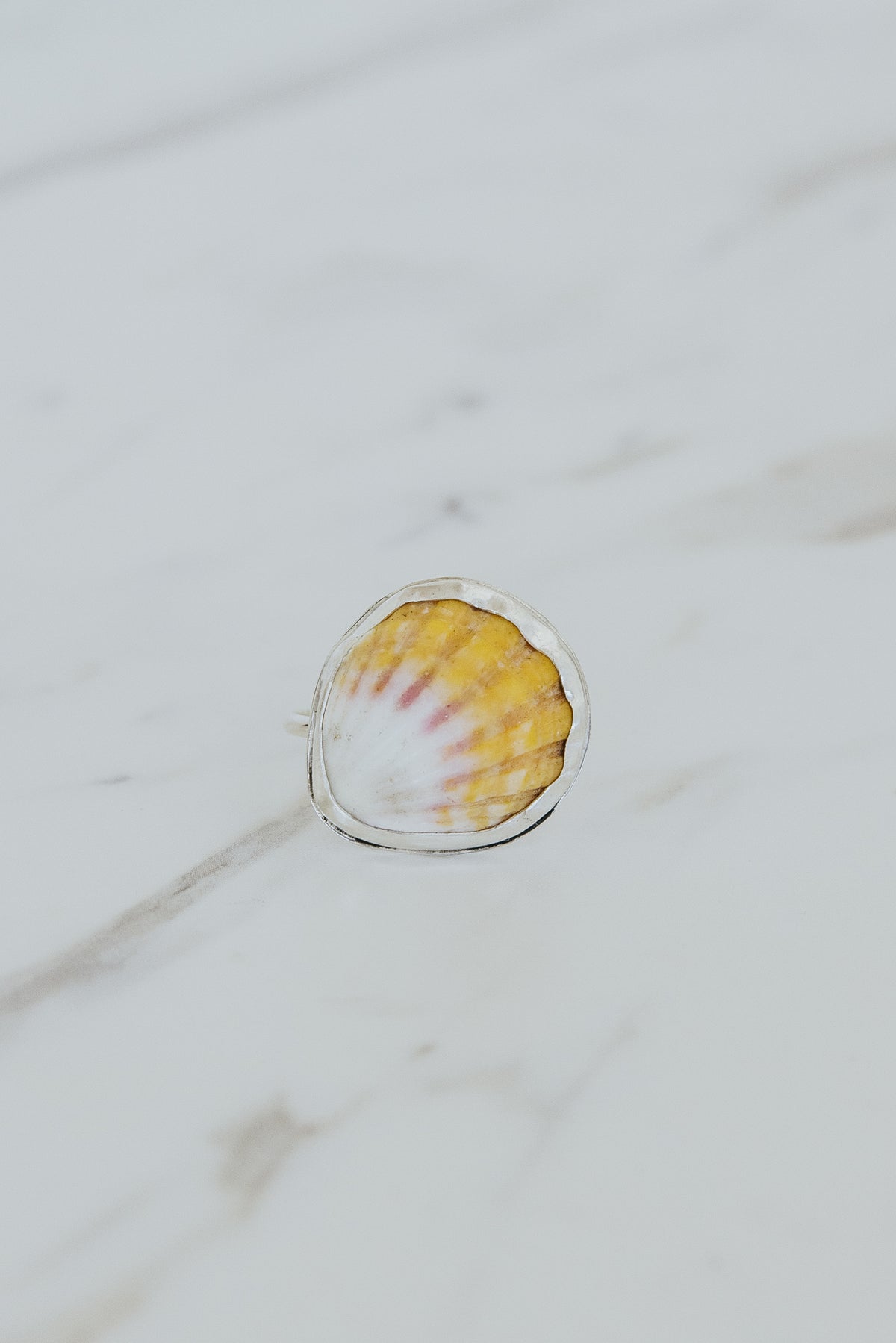 Wings Hawaii bezel-set Sunrise Shell ring bezel-set in sterling silver. Authentic, rare Hawaiian beach shell. Fine jewelry handmade with aloha on Maui. One of a kind gifts made in Hawaii.