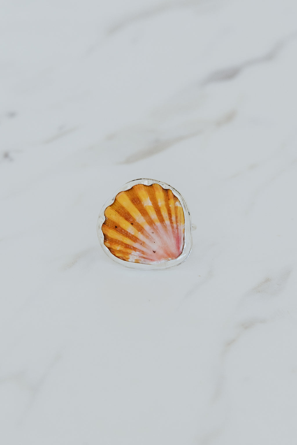Wings Hawaii bezel-set Sunrise Shell ring bezel-set in sterling silver. Authentic, rare Hawaiian beach shell. Fine jewelry handmade with aloha on Maui. One of a kind gifts made in Hawaii.