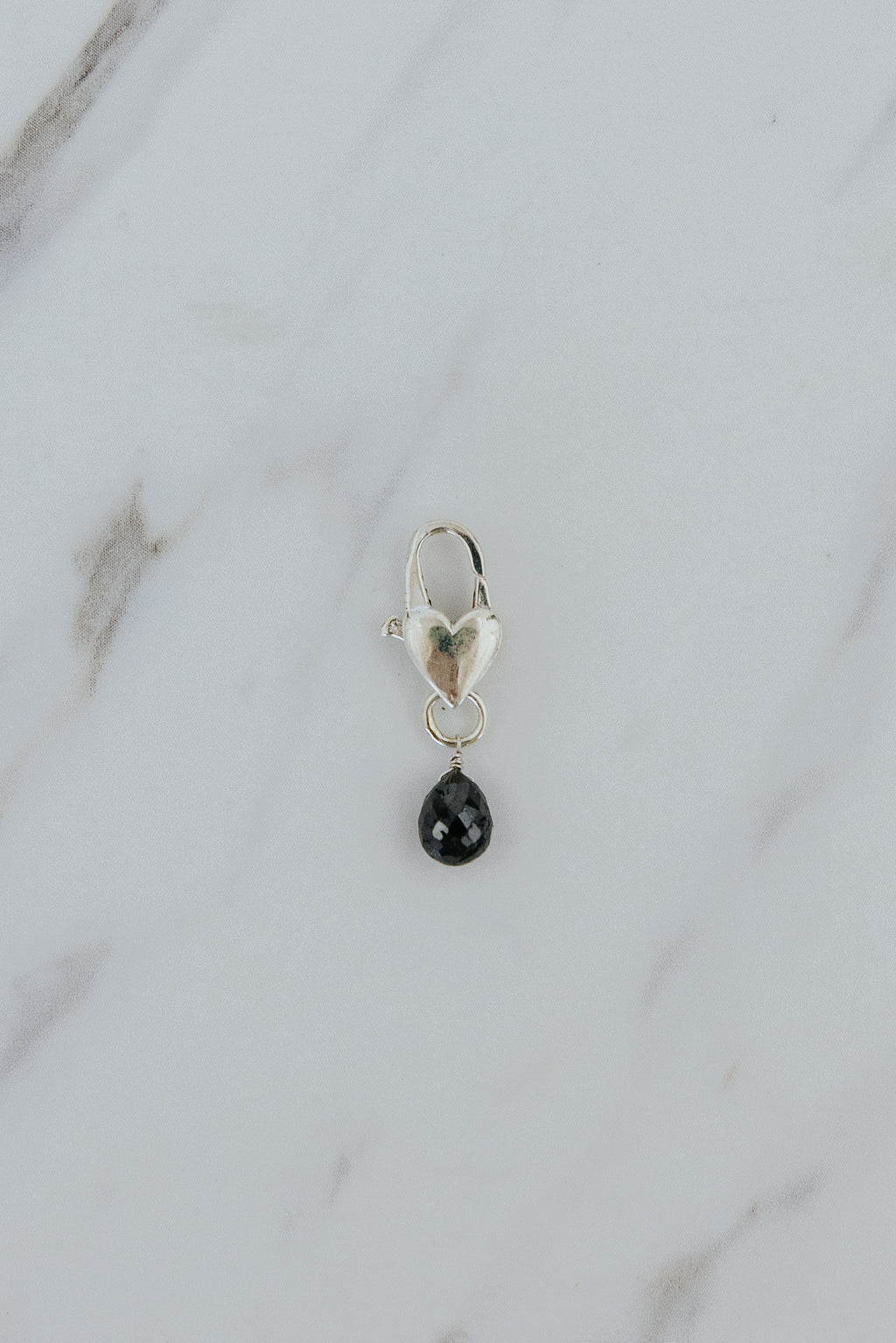 Wings Hawaii Black diamond necklace charm with heart-shaped clasp in sterling silver. Fine jewelry handcrafted in Maui. Modern charm necklaces made in Hawaii