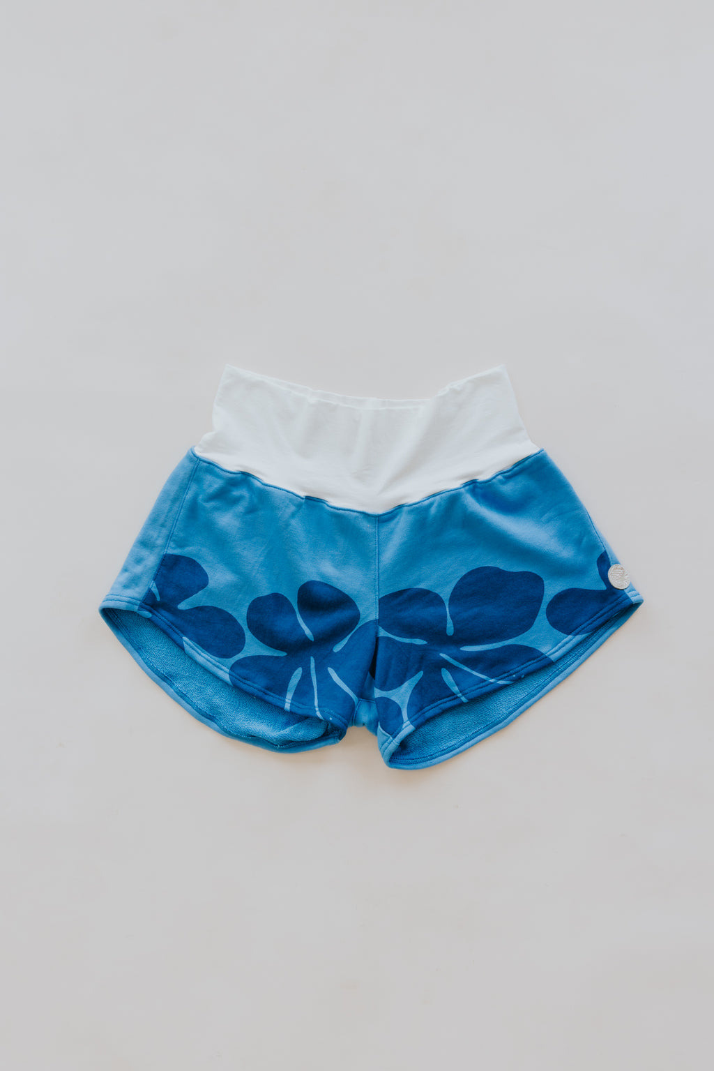 Wings Hawaii best-selling pau hana shorts in hibiscus blue + starmaid. Tropical floral and mermaid print designed in Maui. Modern beachy loungewear. Small batch, sustainable women's apparel from Paia, Maui. 