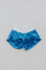 Wings Hawaii best-selling pau hana shorts in hibiscus blue + starmaid. Tropical floral and mermaid print designed in Maui. Modern beachy loungewear. Small batch, sustainable women's apparel from Paia, Maui.  thumbnail