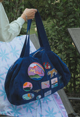 Wings Hawaii patched up cotton duffel bag in blue. Original artwork on embroidered patches - mermaids, surfer girls, whales, tigers, rainbows and more. Handmade with aloha in Maui.  thumbnail