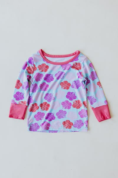 Wings Hawaii Hibiscus print kids pajamas set. Original artwork designed in Maui. Island style keiki gifts. Long sleeved shirt with pajama pants. Small batch, sustainable, unique children’s apparel. 