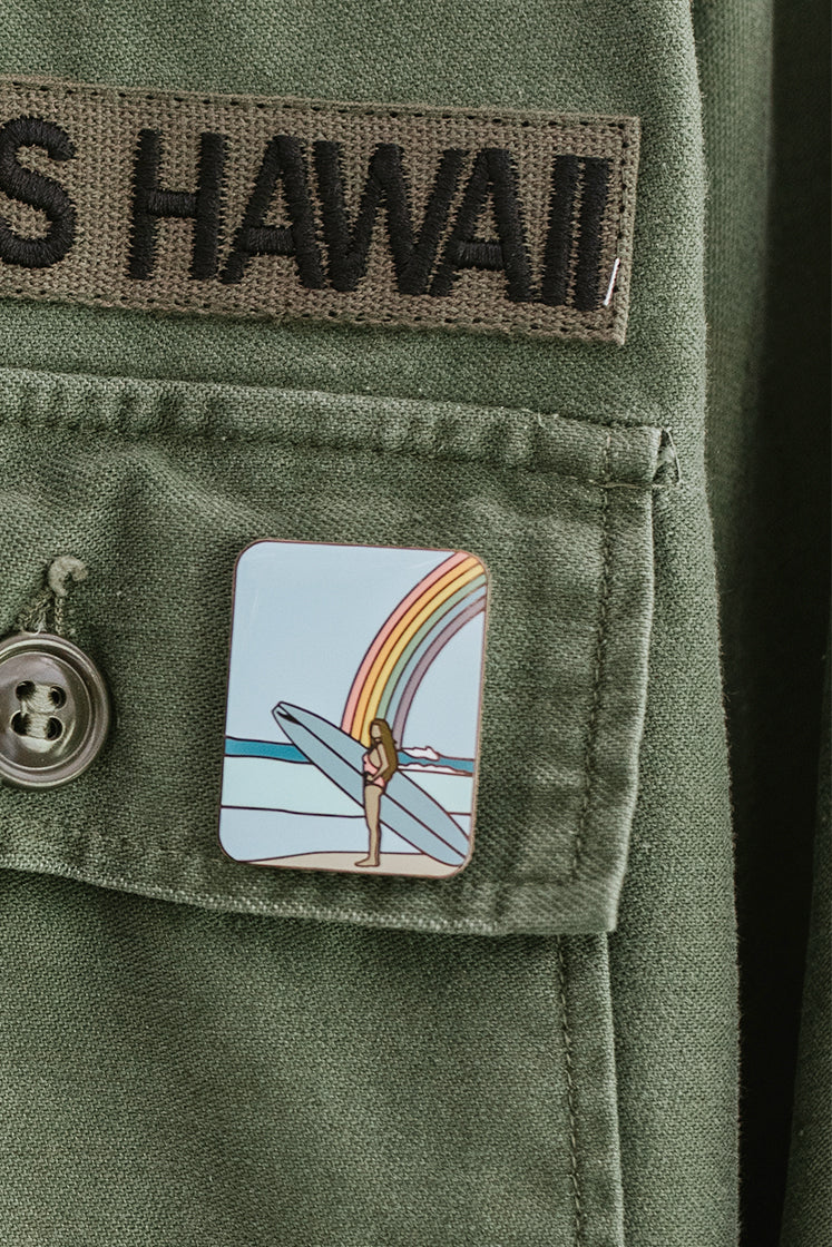 wings hawaii rainbow surfer girl enamel pin shown on jacket