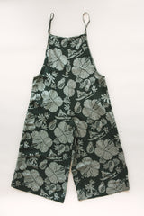 Wings Hawaii women's aloha print overalls in Hana Forest. Designed in Maui, made in Bali. Dark green tropical pattern with hibiscus florals, pineapples, and Hawaiian outrigger canoes. Adjustable straps, wide leg, relaxed fit, front and side pockets. Small batch, sustainable clothing for beachy, boho style.  thumbnail