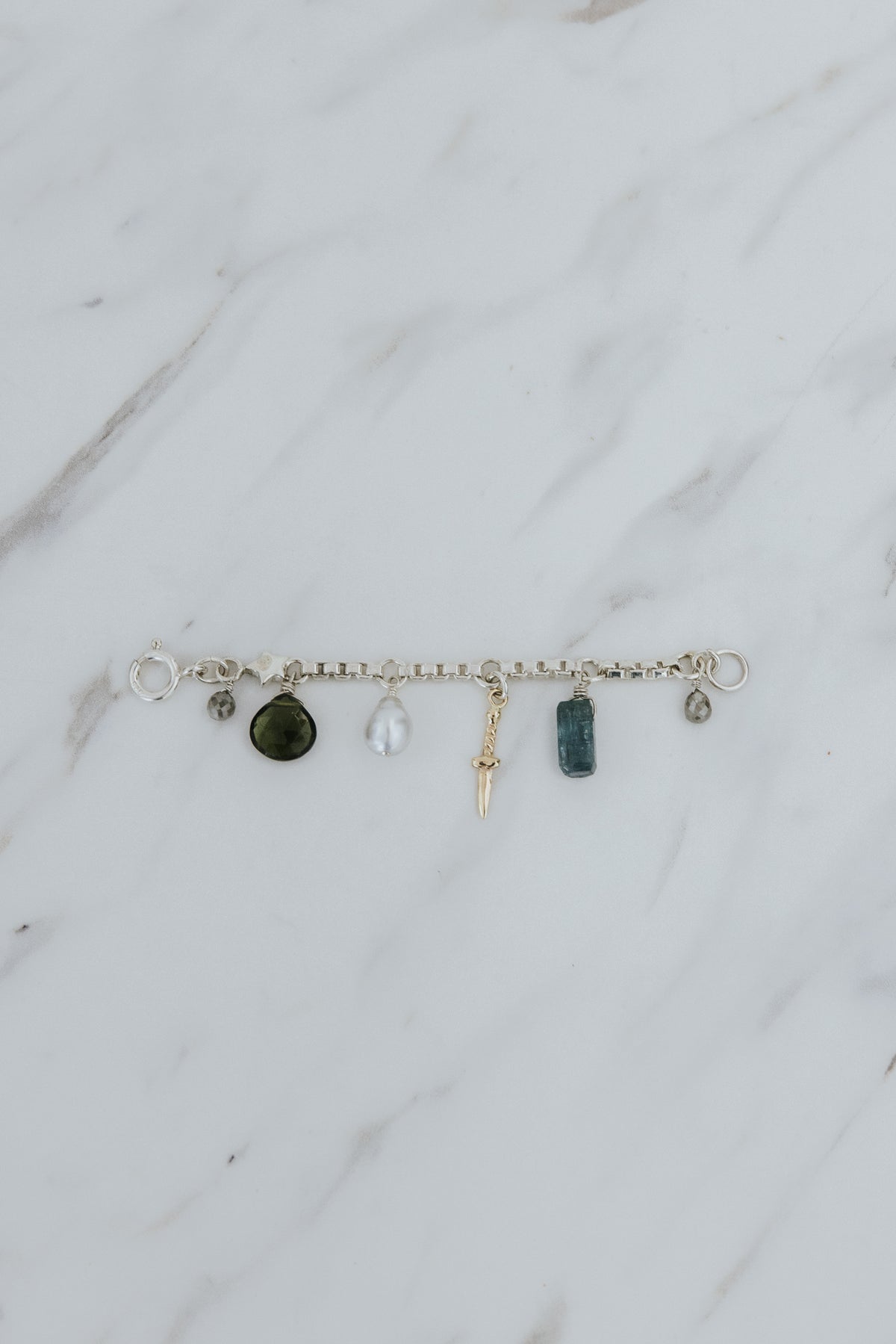 Wings Hawaii Multi Charm Necklace Adapter in sterling silver with solid 14k yellow gold dagger charm, natural Keshi pearl, green Tourmaline teardrop bead, and two .95 tcw diamonds.