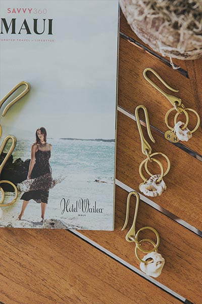 Maui magazine beside gold hook earrings