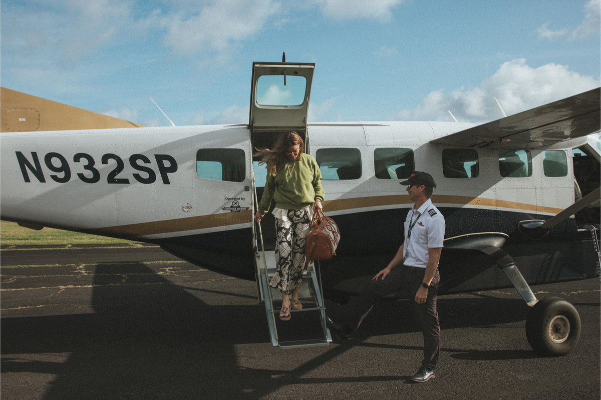 Model stepping off a small plane
