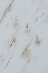 Wings Hawaii Granulated Cowrie Shell charms for necklaces. Fine shell jewelry handcrafted in Maui. Modern beachy charm necklaces handmade with authentic Hawaiian sea shells. 