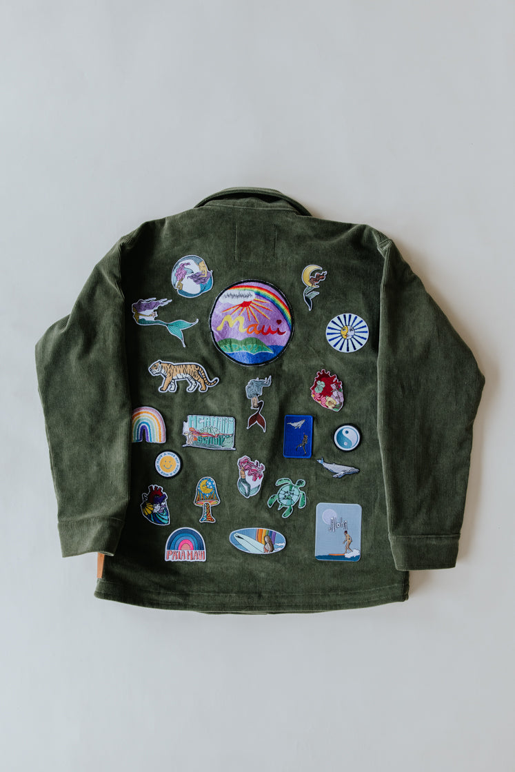 Wings Hawaii patched up army jacket. Handmade in Maui. Upcycled and one-of-a-kind. Original artwork patches with mermaid, sea turtles, rainbows, surfer girls, Maui island, tropical themes and more. 